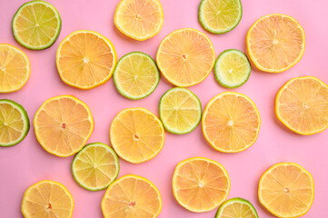 Fresh kiwi and lemon slices on yellow background