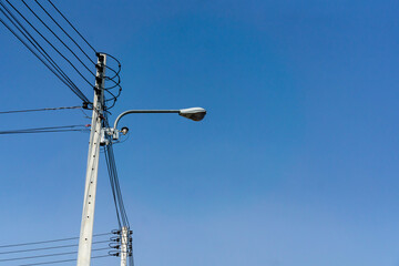 Light pole with electricity wires with blue sky,light and electricity photography,clear sky