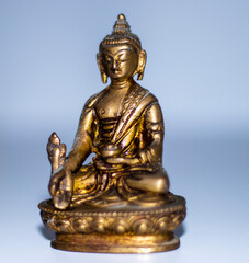 Obraz premium Close up shot of a bronze buddha mini statue. Indoors