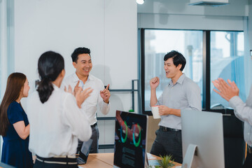 Millennial group of young businesspeople Asia businessman and businesswoman celebrate giving five...