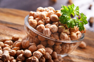 Composition with bowl of chickpeas on wooden table