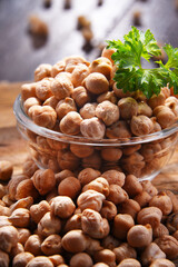 Composition with bowl of chickpeas on wooden table