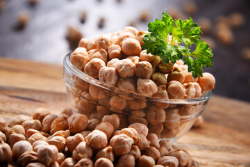 Composition with bowl of chickpeas on wooden table