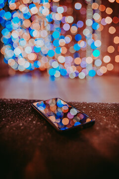 Blurred lights reflection on turned-off smart phone 