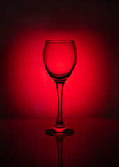 silhouette of transparent  glass  on red background 