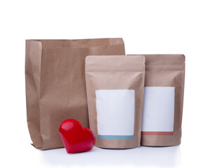 mock up of recycling  paper bag, coffee bean bag and red heart on white background 