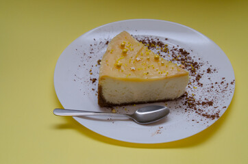 Lemon cheesecake in a white plate with cocoa decoration