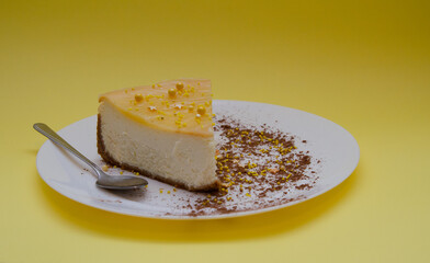 Lemon cheesecake in a white plate with cocoa decoration