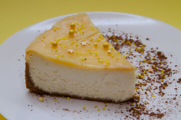 Lemon cheesecake in a white plate with cocoa decoration