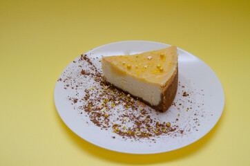 Lemon cheesecake in a white plate with cocoa decoration