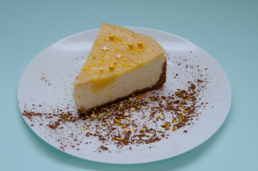 Lemon cheesecake in a white plate with cocoa decoration