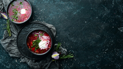 Beetroot soup. Ukrainian traditional cuisine - Borsch soup in a bowl. Rustic style. Top view.