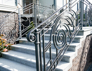 entrance. Iron banister. Elements railing of a beautiful country house, Villa. staircase step with steel handrail.