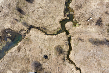 Top view of Ruins of the abandoned wooden houses and small river in the ghost village in the European North of Russia, Kirov Region