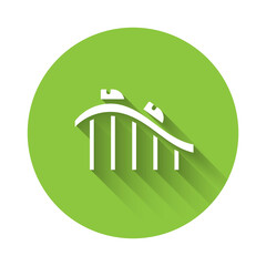White Roller coaster icon isolated with long shadow. Amusement park. Childrens entertainment playground, recreation park. Green circle button. Vector.