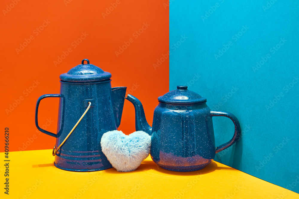 Wall mural valentine's day. blue teapots with a heart between the two on flat colors background. red, blue, yel