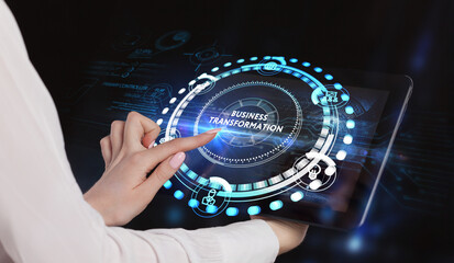 The concept of business, technology, the Internet and the network. A young entrepreneur working on a virtual screen of the future and sees the inscription: Business transformation