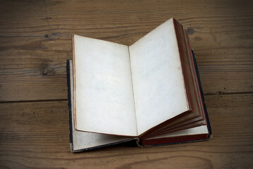 Fototapeta premium Old open book with blank pages on wood background 