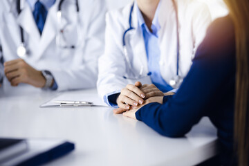 Unknown woman-doctor reassuring her female patient, close-up. Two physicians consulting and giving...