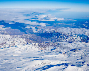 Obraz premium Flight over the Caucasus mountains by plane.
