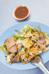 Dried suki in a bowl with dipping sauce on the street food table in Thailand. 