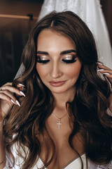 Fototapeta premium Morning of the bride. Preparing the bride for the upcoming wedding. Portrait of a girl.