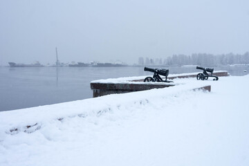 Onega lake embankment with guns in winter