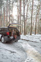 happy family on a walk outdoors in sunny winter forest