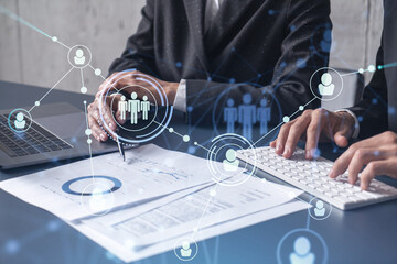 Two HR specialists man and woman analyzing the market of alumni to boost the intern program at...