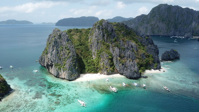 Aerial view of green and brown mountain beside body of water