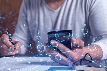 A client is signing the contract to create a software to present it at start up conference and gain investments for innovative service. Checking the details at smartphone. Hologram tech graphs.