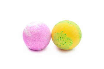 Aroma yellow-green and pink bubbling round bright bath bombs isolated on a white background. Close-up of bath salts