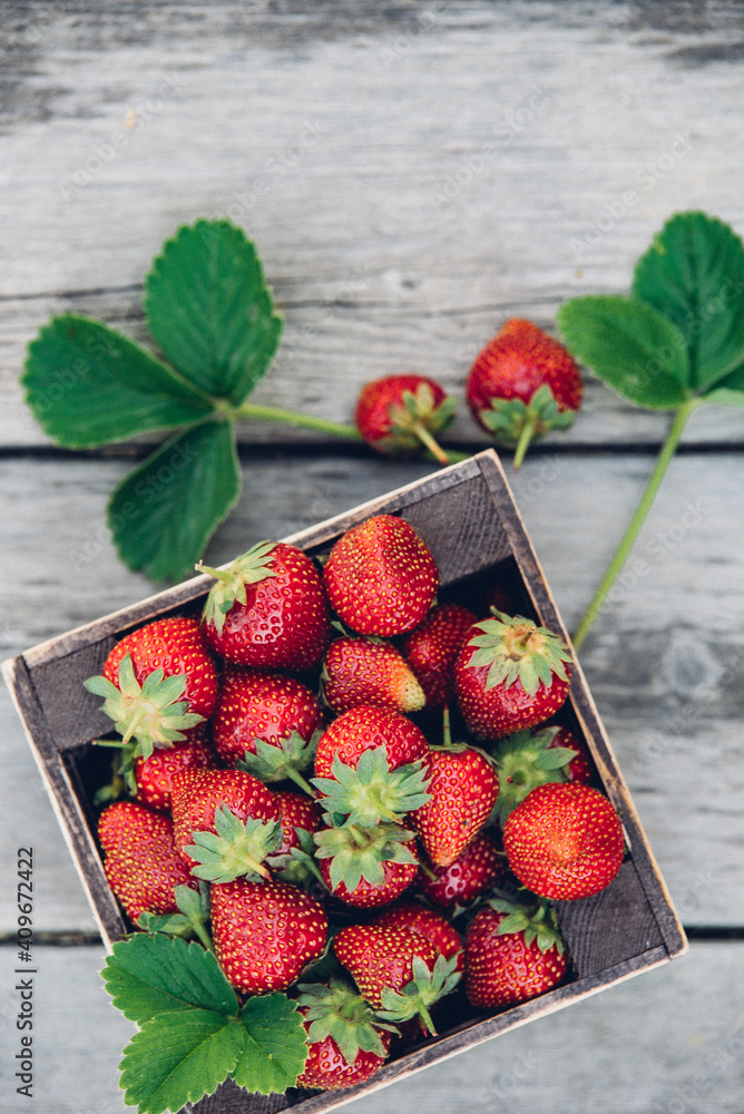 Wall mural Fresh juicy strawberries with leaves. Rustic wooden box and handmade lace. Retro magazine picture. Strawberry with copy space