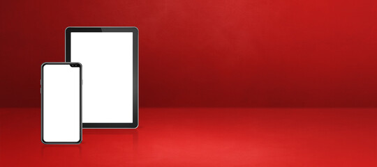 Mobile phone and digital tablet pc on red office desk. Background banner