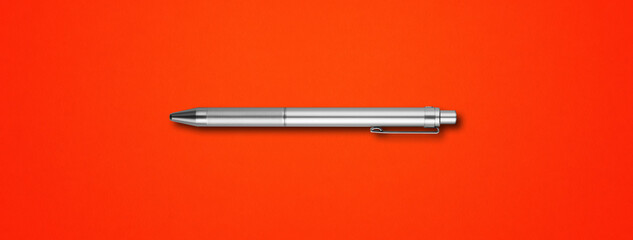 Metal pen isolated on red background