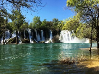 Kravica waterfalls is a large tufa cascade on the Trebižat River, in the karstic heartland of Herzegovina in Bosnia and Herzegovina. - obrazy, fototapety, plakaty