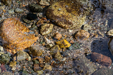 Transparent river with stones at the bottom.