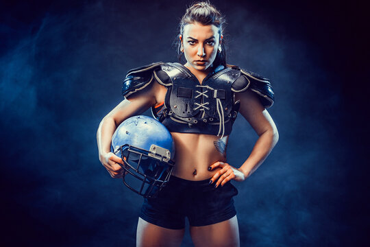 Young brunette wearing sexy uniform of rugby football player posing.