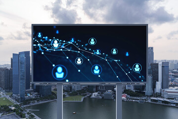 Glowing Social media icons on billboard over sunset panoramic city view of Singapore. The concept...