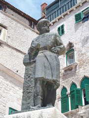 the bronze monument by the sculptor ivan mestrovic on republic square in sibenik, croatia, depicts the cathedral builder juraj dalmatinac