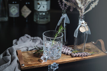Gin and Tonic drink served with ice and fresh rosemary. Drink Concept. Dark Rustic style. Copy...