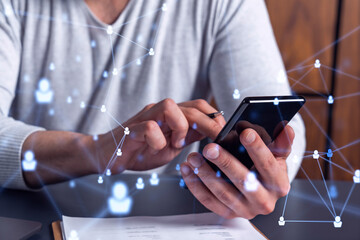 Hands of hr specialist browsing social networks in the Internet in smart phone to find the best candidates to hire international team. Concept of success. Media hologram icons.