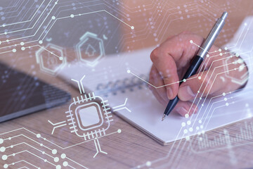 Hands writing down some ideas to create innovative software to change the world and provide a completely new service. Close up shot. Hologram tech graphs. Concept of Dev team. Formal wear.