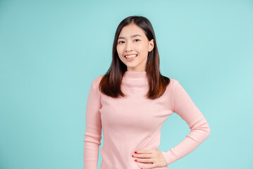 Dental braces of young asian woman wearing retainer braces glad emotion with white teeth increase confidence for healthy on blue background isolated, Happiness teenager smiling facial expression. - obrazy, fototapety, plakaty