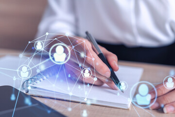 Woman HR specialist is taking notes concerning new candidates to create international network in...