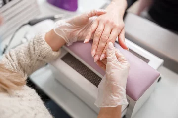 Photo sur Plexiglas ManIcure Professional manicure master is doing nails for happy client in beauty salon