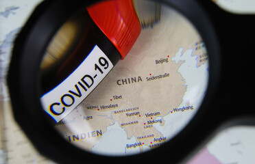 Viersen, Germany - March 28.2020: View through magnifying glass on map with focus on China and...
