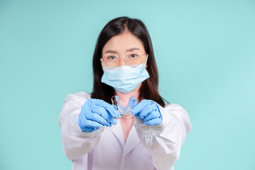 Asian dentists are teaching them how to care for oral and dental care, including after correct orthodontic treatment on blue background isolated studio shot.