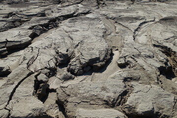 Water-washed land. Cracked crumbling clay and sandy soil after the snow melts in the spring or flood. concept of soil erosion climate change and sudden changes in air temperature and natural disasters