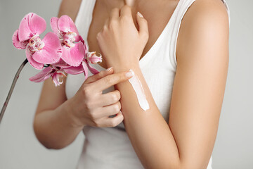 Closeup woman applying protective cream on hands. Hand skin care. Cosmetic cream